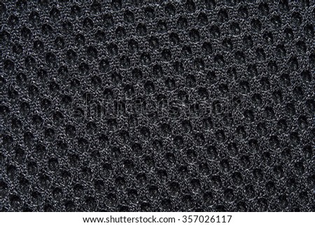 Black fabric texture with pattern, with sagging inside the ovals. The texture of the fabric. Closeup