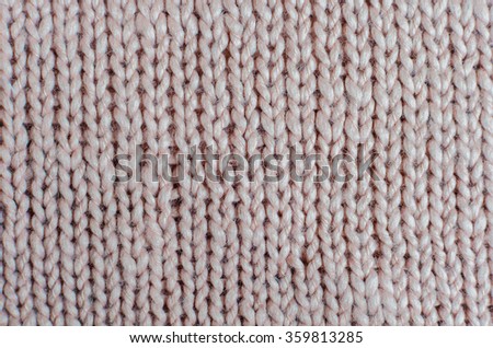 pink knitted sweater textured background for your text. closeup creamy vintage toning.