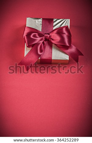 Giftbox on red background holidays concept.