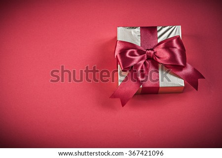 Gift box on red background holidays concept.