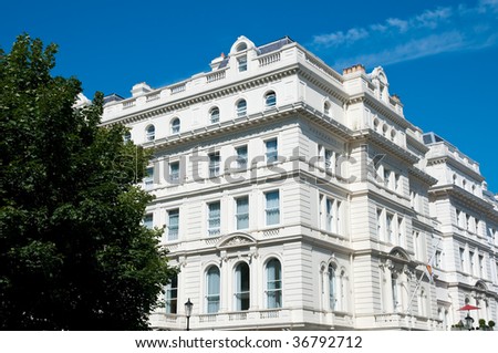 Beautiful building in the lancaster gate area of london, with a tree in the foreground
