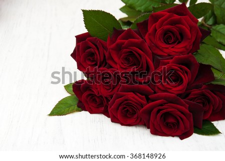 Fresh Red roses on a old wooden background