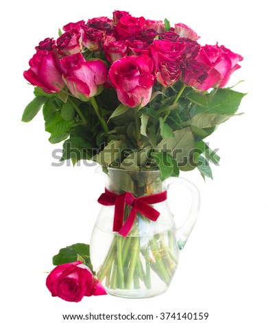 Bunch of dark pink  rose flowers in glass vase  isolated on white background