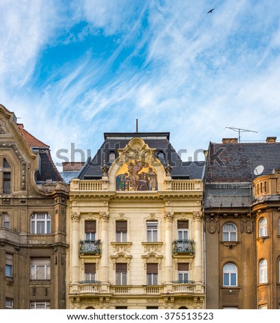 Old and beautiful architecture of Budapest, Hungary, Europe. Building in foreground with blue sky and clouds in background.