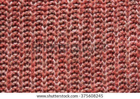 Salmon red, orange knitted sweater texture background. Space for copy, text, lettering.