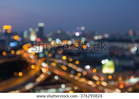 Abstract blurred bokeh highway interchange with office building background night view
