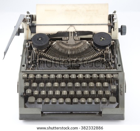 Old typewriter with blank sheet on white