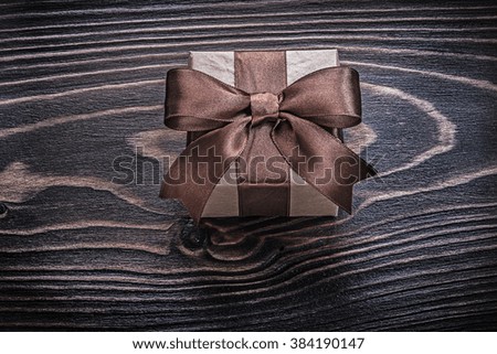 Wrapped present box on wooden board holidays concept.