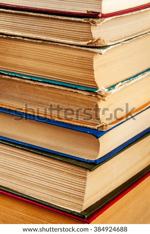 Old books on a wooden shelf.
