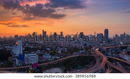 Beauty of sunset over city downtown and highway interchanged