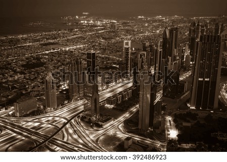 Dubai downtown night scene with city lights. Top view from above