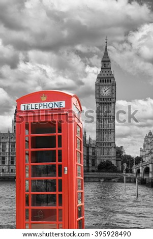 A  traditional red phone booth in London with the Big Ben