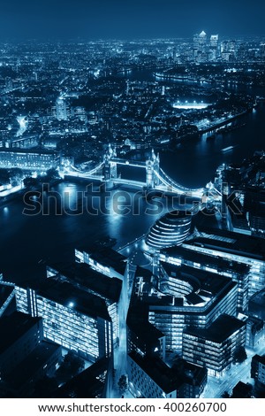 London aerial view panorama at night with urban architectures and Tower Bridge in BW.
