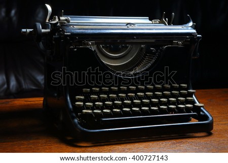 left front of Historic dark typewriter on the wooden table 
