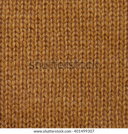 Pastel yellow wool knitted fabric texture. Close up fragment of the top view.