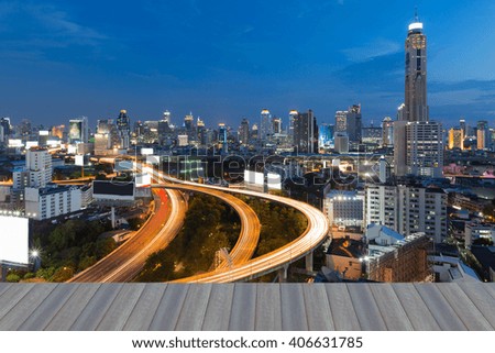 Opeing wooden floor, View of the Bangkok Skyscraper with highway during twilight