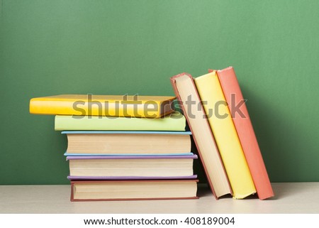 Stack of colorful books on table. Education background. Back to school. Copy space for text.