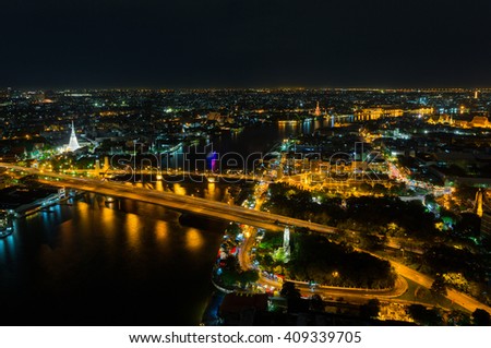 Bangkok cityscape along Chao Phraya river view with many buildings at night ,Thailand.