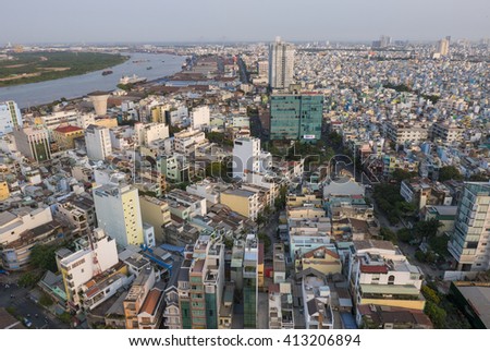 Ho Chi Minh City skyline aerial view with small colored residential houses and the river, medium class district of the capital of Vietnam