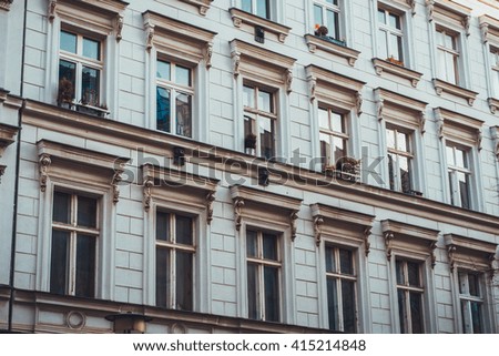 beautiful old white facade with blue windows