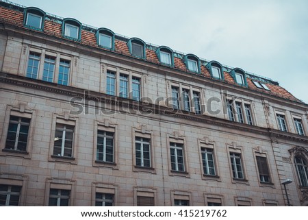 Low angle view on German classical revival apartments with eyebrow style dormer windows and clay tile roof