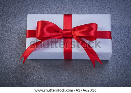 Present box on grey surface holidays concept.