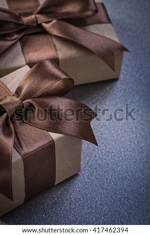 Composition of giftboxes in brown paper on grey background celebrations concept.