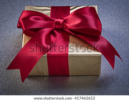 Boxed gift on grey background top view holidays concept.