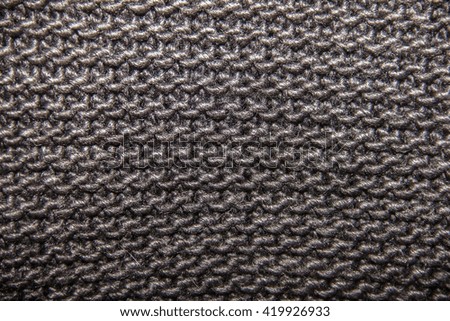 knitted woolen fabric of black color, large loop, texture and background