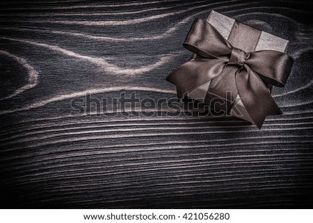 Present box on wooden board holidays concept.