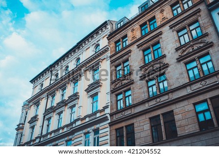 Low Angle Architectural View of Low Rise Urban Buildings with Classical Features in Urban Munich, Germany with Cloudy Blue Sky in Background