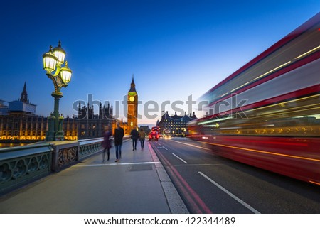 London scenery at Westminster bridge with Big Ben and blurred red bus, UK