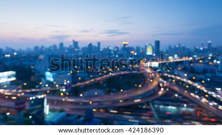 Blurred bokeh lights, Highway interchanged and city downtown background after sunset