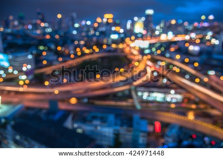 blurred bokeh lights of city downtown background and highway