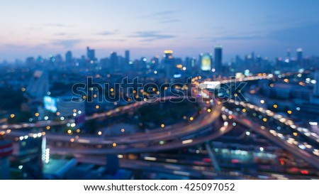 Blurred bokeh lights, Highway interchanged and city downtown background after sunset