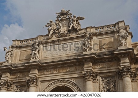 The palace facade as a part of the Trevi fountain in Rome, Italy. The inscriptions pay homage to the popes involved in the construction.