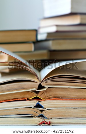 stacks of old opened books, closeup view