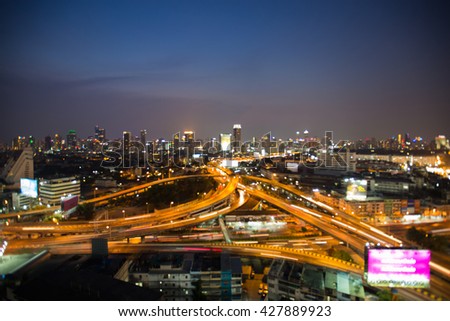 Abstract blurred bokeh lights highway interchanged and city downtown background, night view