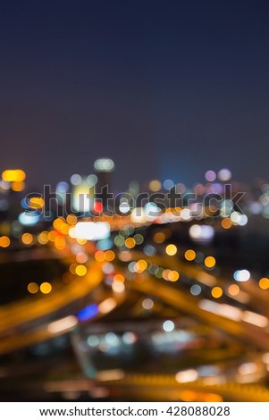 Night view, abstract blurred bokeh lights highway interchanged and city downtown background