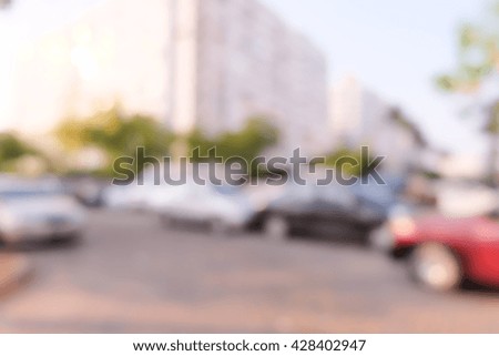 blurred car in parking lot ,city background.