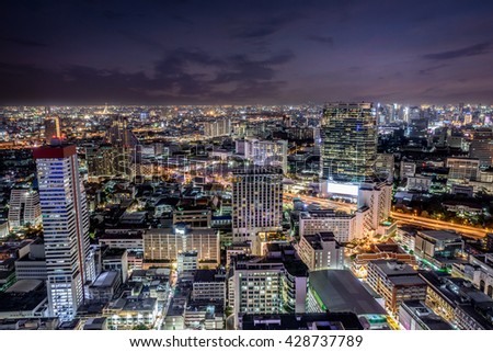 Illuminated cityscape of the city of Bangkok, Thailand, with cloud and overlay filters applied on the sky