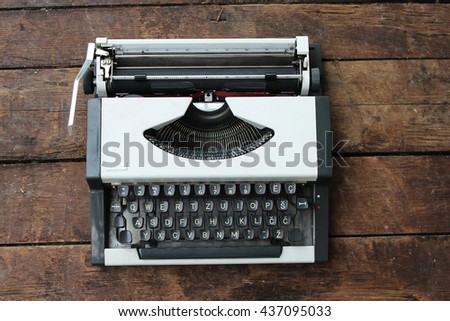 Typewriter on old wooden background