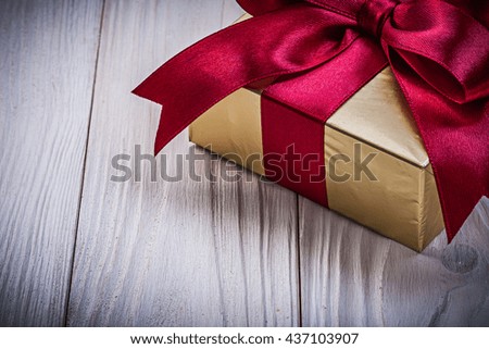 Packed present box on wooden board holidays concept.