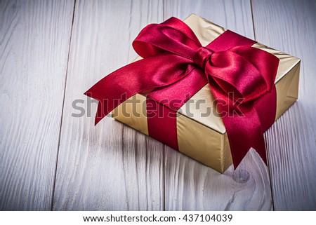 Wrapped present box on wooden board top view holidays concept.