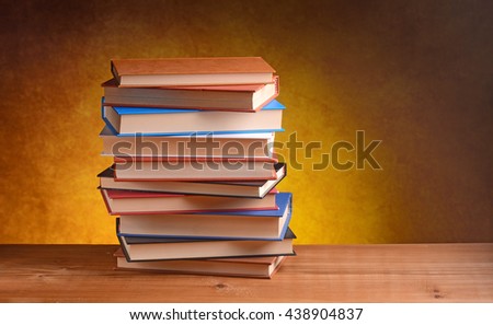 pile of books on the wooden table