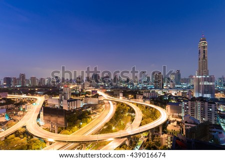 Before sunrise over highway road long exposure and city residence downtown background