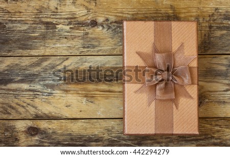 brown gift box on old wooden table, retro style