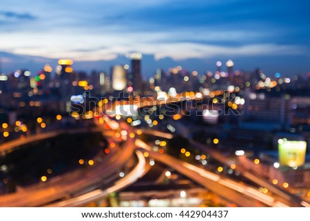 Abstract blurred light at twilights, overpass highway interchanged with city downtown background