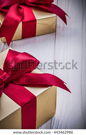 Gift boxes with satin ribbons on wooden board holidays concept.