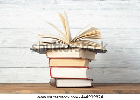 Open hardback books on wooden table. Education background. Back to school. Copy space for text